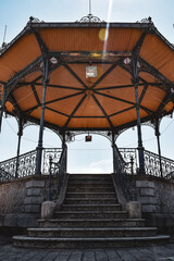looking up steps into town centre music bandstand building with  blue skies in summer
