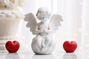 figurine of white angel with wings and hearts.