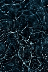 Black water with ripples on the surface. Defocus blurred transparent blue colored clear calm water surface texture with splashes and bubbles. Water waves with shining pattern texture background.