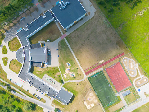 school sports ground with football stadium, jogging tracks around. basketball, volleyball, tennis courts. aerial photo, top view.