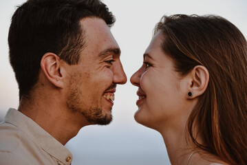 Portrait of beautiful young loving couple man of Middle Eastern appearance and a Caucasian woman look at each other.