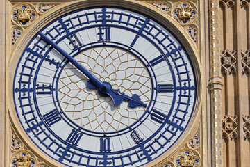Detail of Big Ben Clock Tower in London, UK in a day with white clouds and blue sky.