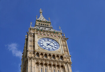 Fototapeta na wymiar Big Ben Clock Tower in London, UK in a day with white clouds and blue sky.