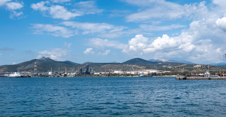 Elefsina Petroleum Oil Refinery known as Hellenic Energy, Attica Greece. wavy sea blue sky.