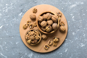 Fresh healthy walnuts in bowl on colored table background. Top view Healthy eating bertholletia concept. Super foods