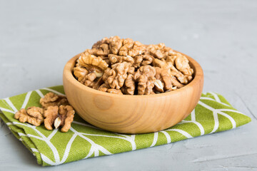 Fresh healthy walnuts in bowl on colored table background. Top view Healthy eating bertholletia concept. Super foods