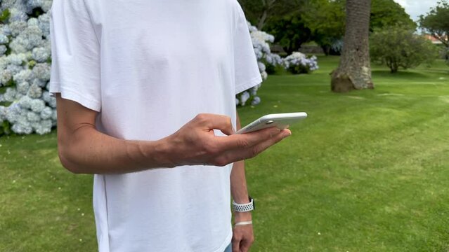 Close up view of male hands using smartphone scrolling, browsing, surfing internet, social media browsing slow motion