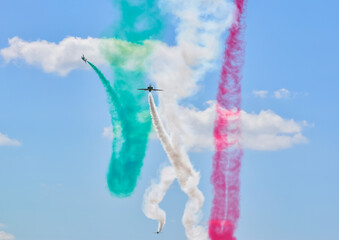 green saudi Hawks falcons aerobatic team fighter jet with blue skies in formation with red white...