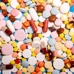 Many colorful different medicines and pills on top. The concept of medical treatment