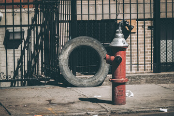 Red fire hydrant and tire, streets of New York