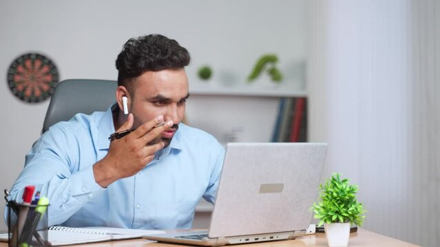 Happy indian businessman on online video call or meeting on laptop at office - concept of entrepreneur, financial advisory and communication skills.