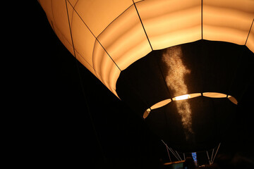 A fragment of inflating a passenger large balloon by heating the air at night. Preparing a thermal balloon for flight. 