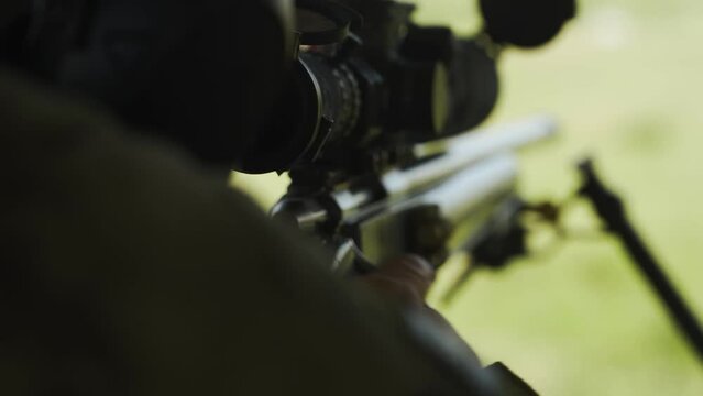 A sniper shoots a rifle at a shooting competition. Close-up