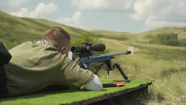 A sniper shoots at a target several times with a sniper rifle 