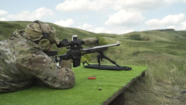 A military man shoots a sniper rifle at targets. Shooting practice