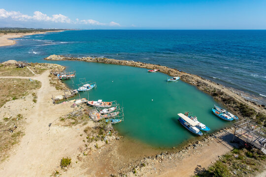 Aerial view of small manmade primitive fishing port on the Mediterranean Sea coast of Belek, Antalya, Turkey.