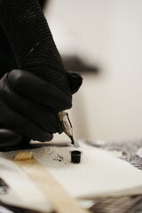 Dive into the world of body art with this captivating close-up of a tattoo machine replenishing ink...