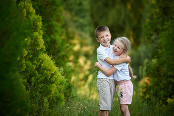 Fototapeta premium Little brother and sister hugging and happy together in the park