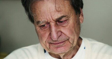 Older man suffering from depression portrait face closeup