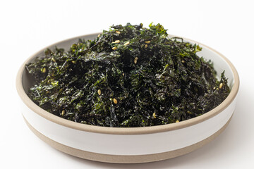 Seasoned, dried and grilled seaweedflake on a white background