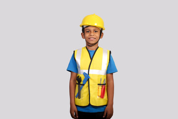 Small asian kid engineer wearing helmet and Safety jacket standing on isolated Grey background