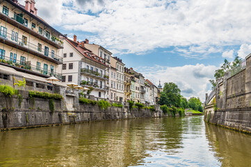 Fototapeta na wymiar A view from the Cobblers bridge down the Ljubljanica River in Ljubljana, Slovenia in summertime 