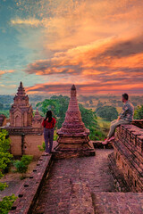 Bagan Myanmar, Sunrise above temples and pagodas of Bagan Myanmar, Sunrise Pagan Myanmar temple and pagoda. Men and woman at an old pagoda