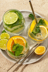 Mojito cocktail with citrus lime, lemon and orange on the beach