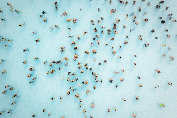 Aerial view of people doing a bath in a huge pool, Sicily, Italy.