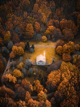 Aerial view of a tiny house surrounded by Colourful trees, Madonie, Sicily, Italy.