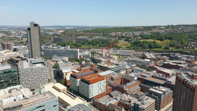 Aerial drone video of the city centre in Sheffield England with many office buildings