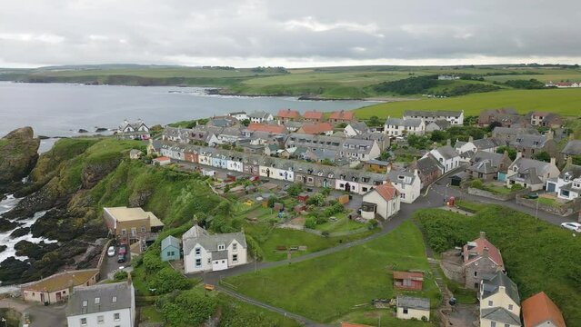 Aerial drone video of the small harbour village St. Abbs in Berwickshire, Scotland