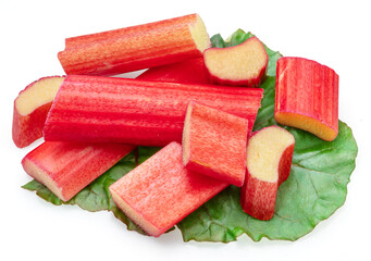 Red rhubarb stems' cuts over rhubarb leaves isolated on white background.