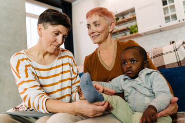 Mature lesbian couple playing with their adopted son