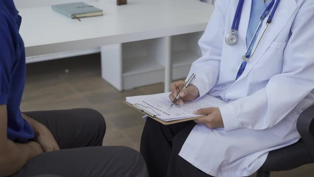 Man with benign prostatic hyperplasia being examined and consulting Asian female doctor and The doctor will ask about the patient's illness and give health advice.