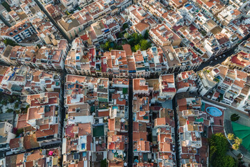 Aerial top down view of Sitges downtown with red rooftops and residential district, Barcelona, Spain.