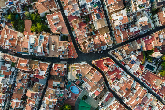 Aerial top down view of Sitges downtown with red rooftops and residential district, Barcelona, Spain.