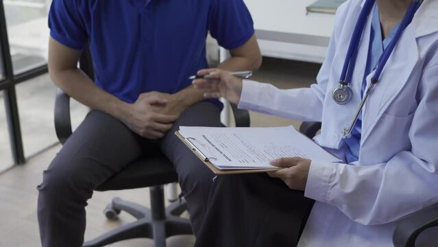 Man with benign prostatic hyperplasia being examined and consulting Asian female doctor and The doctor will ask about the patient's illness and give health advice.