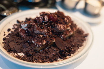 sweet chocolate cake and cookie on a plate with nuts