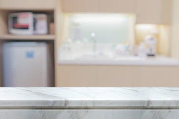 Fototapeta na wymiar white marble stone counter top with blurred kitchen background