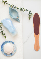 Cosmetic tube in form of leg. Nourishing cream on heels of feet with dry cracked skin. Home foot care and treatment of dermatitis, eczema, dryness. Concept of beauty products and body or foot care. 