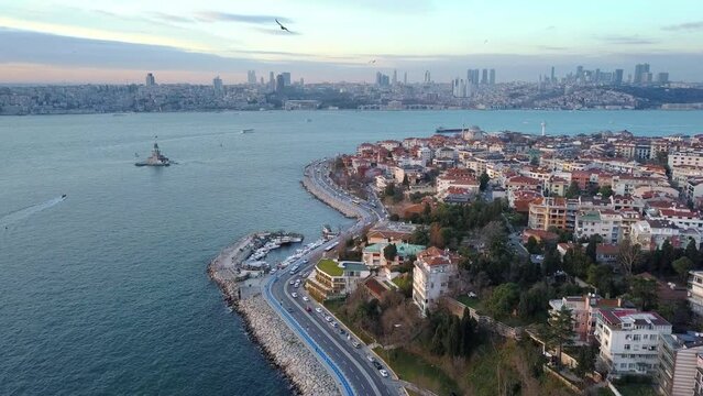 Salacak, Uskudar Region in Istanbul. Traffic on coastal way, parked cars on street and housing along the Bosphorus Sea. Aerial drone Birds eye view establishing shot of the city
