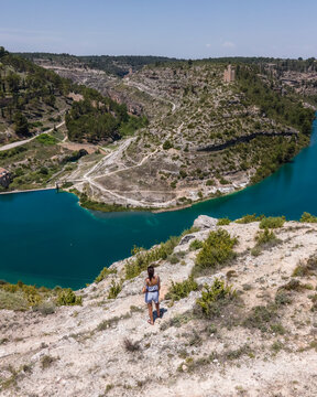 Aerial view of a woman in Alarcon, a medieval town with castle on top along the Rio Jucar river in Cuenca, Spain.