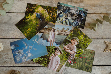 Printed photos on wooden board. Top view. Photo printing concept.