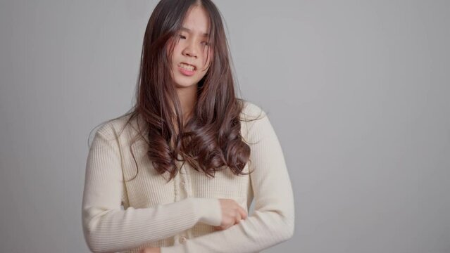 Portrait of Asian angry and sad hipster girl on a white screen background, The emotion of a hipster when tantrum and mad, expression of grumpy emotion. Teenager emotional control concept