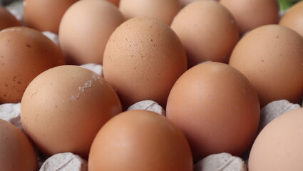 Chicken brown eggs in packing, the top view. Food, close up.