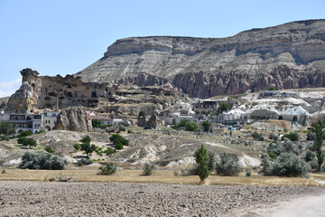 View of the rock church and the village of Cavusin in Cappadocia, Turkey