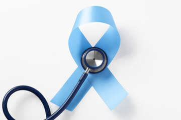 Blue ribbon with stethoscope on white background, prostate cancer awareness month, world diabetes day