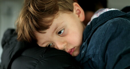 Sleepy child on mother shoulder tired toddler falling asleep