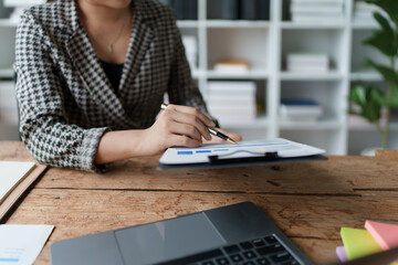 financial, Planning, Marketing and Accounting, portrait of Asian employee checking financial statements using documents and calculators at work